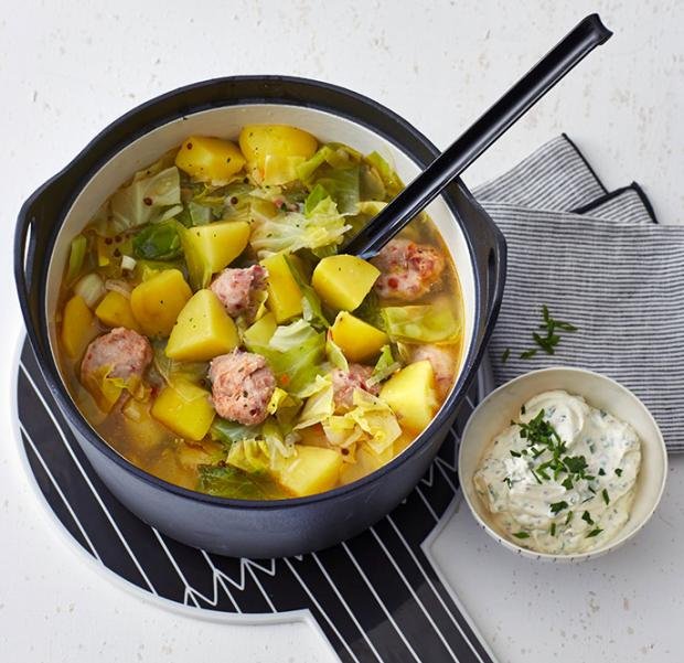Гювеч със зеле, картофи и наденички и купичка със сос