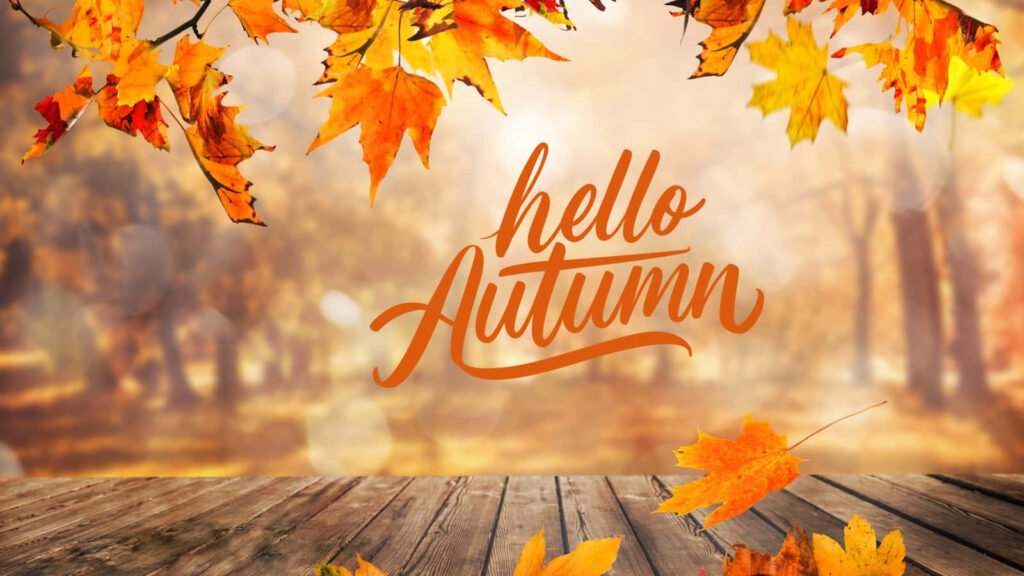 Есенни листа над дървена маса и надпис hello Autumn